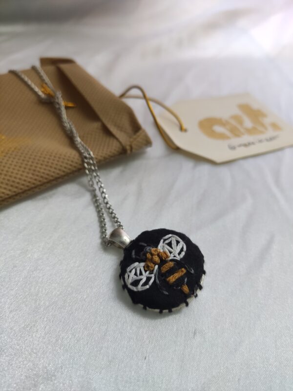 bee embroidered pendant