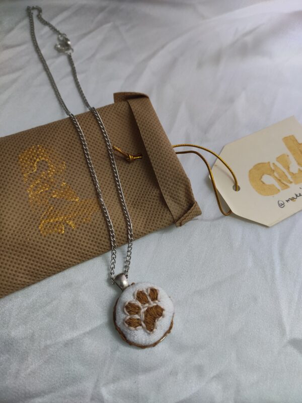 paw embroidered pendant