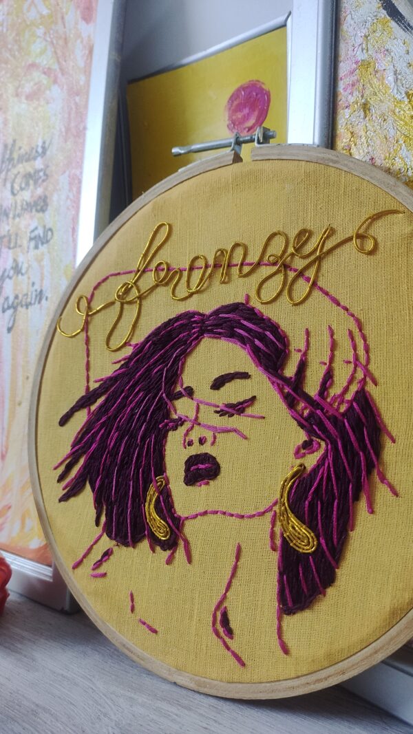 embroidered hoop art with blowing hair in wind girl frenzy written on it
