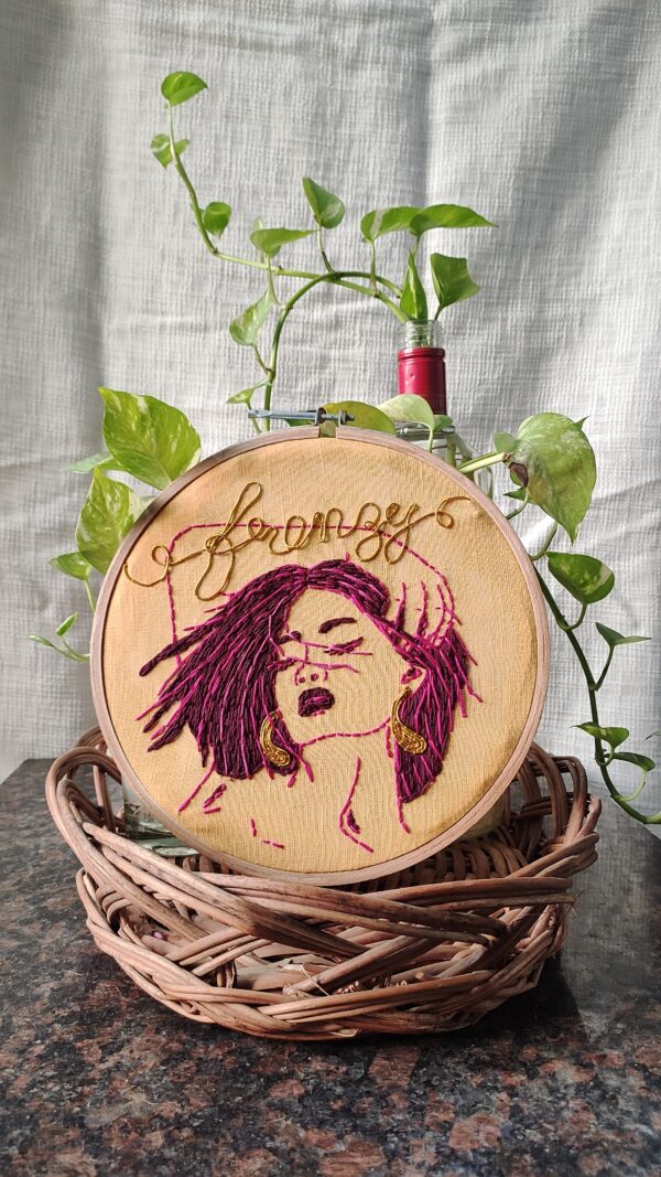 embroidered hoop art with blowing hair in wind girl frenzy written on it