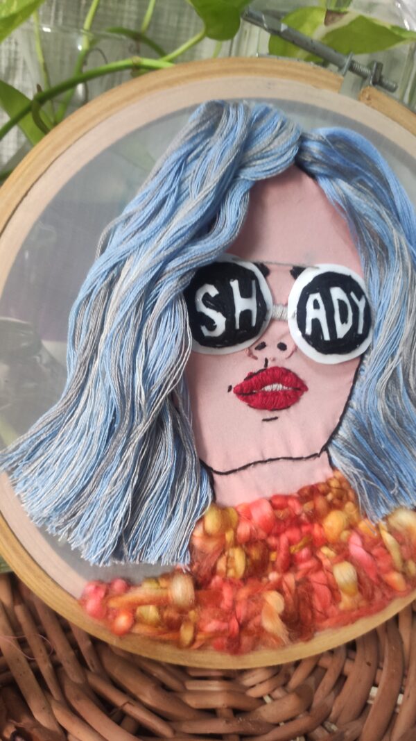 embroidered hoop art of a girl 3d hair with sunglasses written shady on it