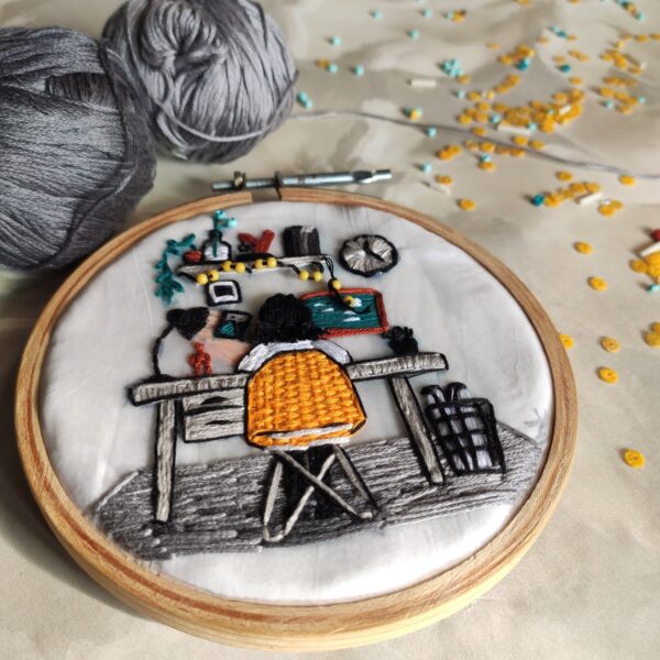 embroidered hoop art of girl working